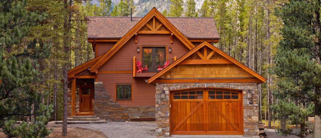 A house with two cars parked in front of it.